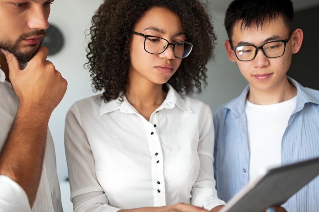 Serious diverse programmers using tablet